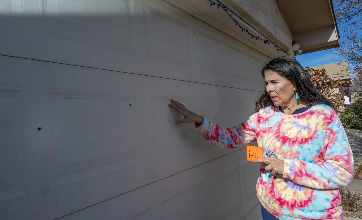 Sen. Linda Lopez, (D-Albuquerque), shows bullet holes in her garage door after her Westside home was shot at last month in Albuquerque, N.M., on Jan. 5 , 2023. (Adolphe Pierre-Louis/The Albuquerque Journal via AP)