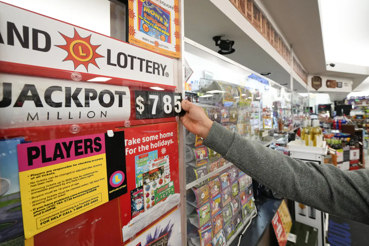 A clerk at Broad Street Liquors updates the Mega Millions jackpot at the store's lottery counter in Timonium, Md., on Jan. 3, 2023. (Julio Cortez/AP Photo)