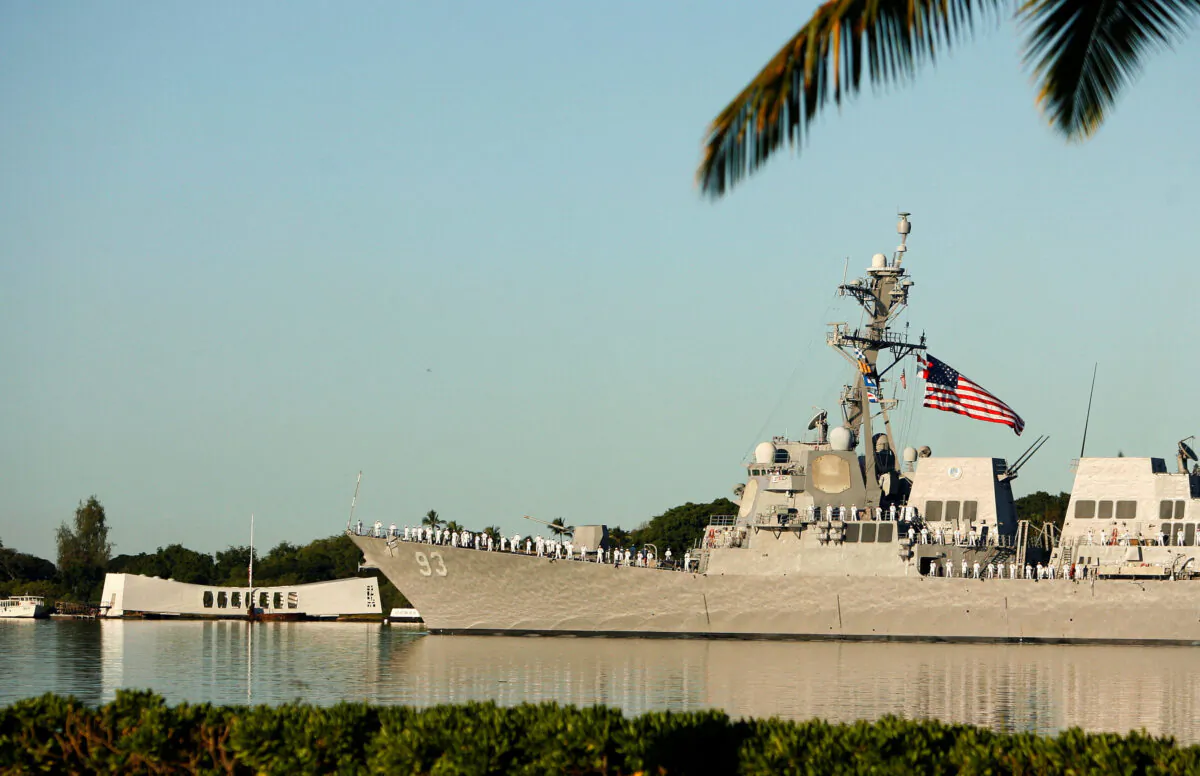 The USS Chung-Hoon passes the USS Arizona Memorial during ceremonies honoring the 73rd anniversary of the attack on Pearl Harbor at the World War II Valor in the Pacific National Monument in Honolulu on Dec. 7, 2014. (Hugh Gentry/Reuters)