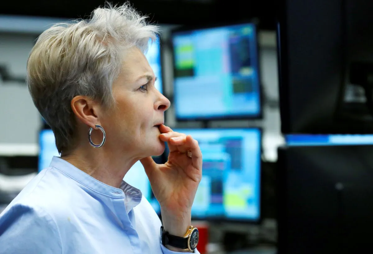 A woman looks at an electronic board displaying Japan's Nikkei index outside a brokerage in Tokyo on Aug. 29, 2022. (Kim Kyung-Hoon/Reuters)