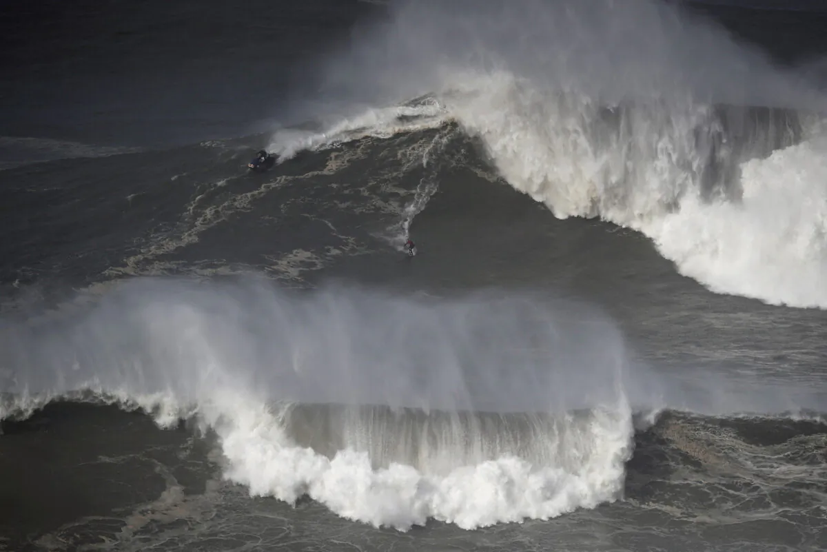 A surfer rides a wave in Praia do Norte, Nazare, Portugal, on Feb. 25, 2022. (Pedro Nunes/Reuters)