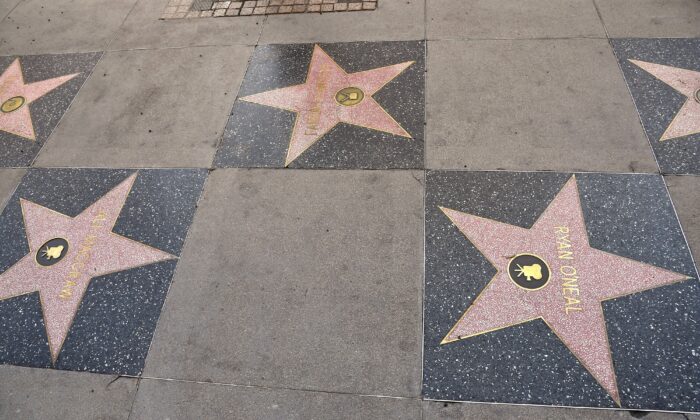 A view of Ryan O'Neal and Ali MacGraw's stars next to Farrah Fawcett's on the Hollywood Walk of Fame in Hollywood, Calif., on Feb. 12, 2021. (Frazer Harrison/Getty Images)