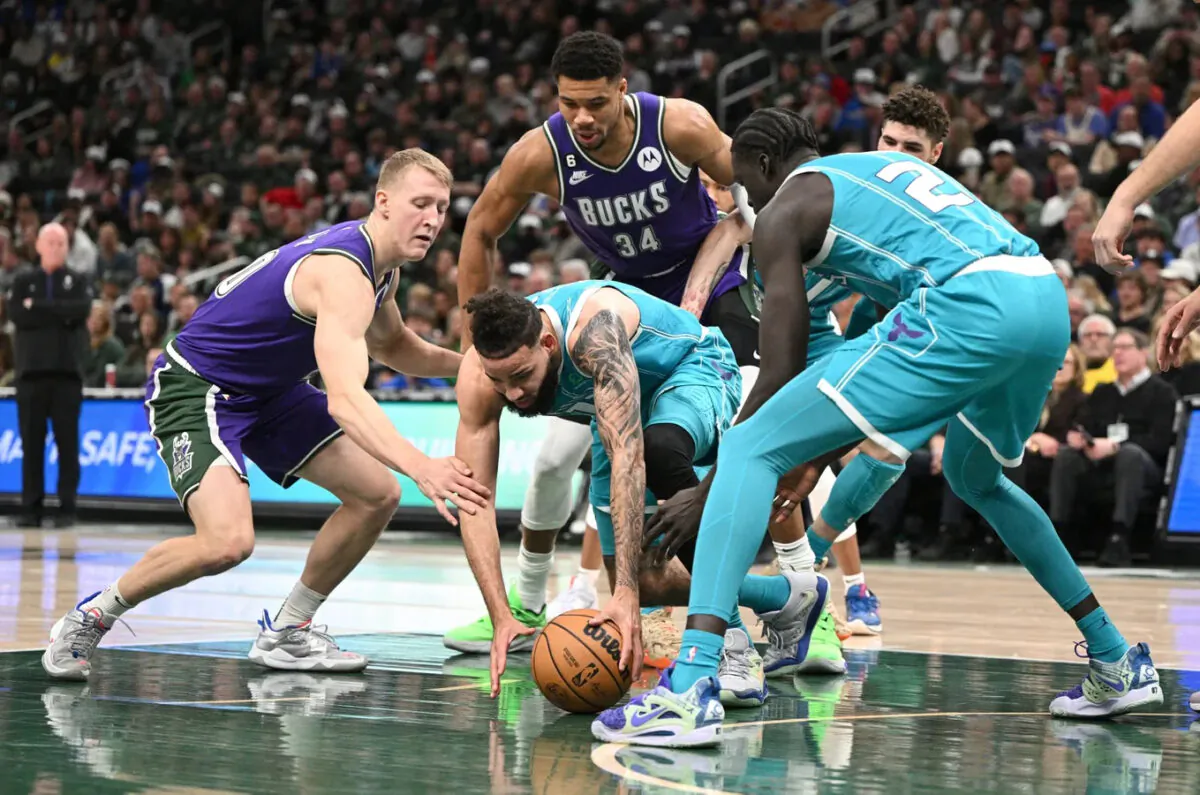 Charlotte Hornets forward Cody Martin (11) and Milwaukee Bucks guard AJ Green (20) scramble for a loose ball in the first half at Fiserv Forum in Milwaukee, Wis., on Jan. 6, 2023. (Michael McLoone/USA TODAY Sports via Field Level Media) 