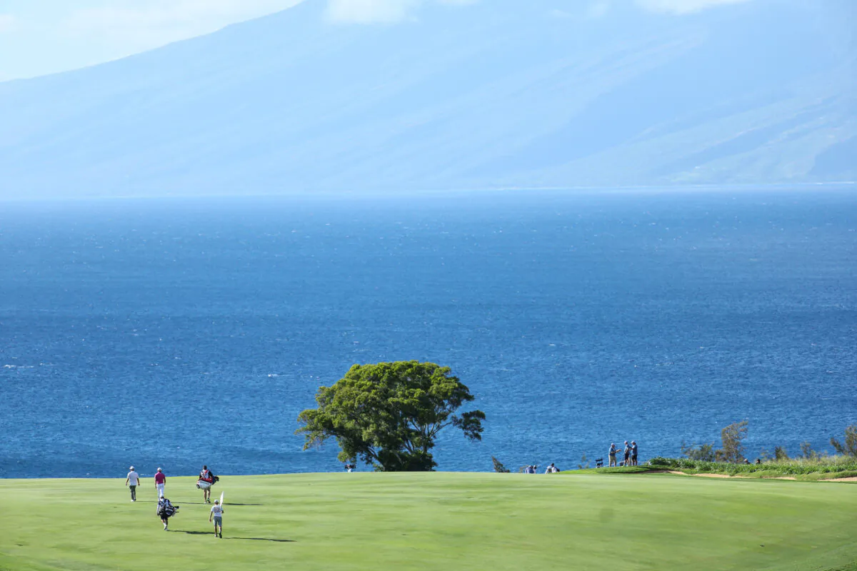 A general view is seen as Collin Morikawa of the United States and J.J. Spaun of the United States walk with their caddies down the 12th fairway during the second round of the Sentry Tournament of Champions at Plantation Course at Kapalua Golf Club in Lahaina, Hawaii on Jan. 6, 2023. (Andy Lyons/Getty Images)