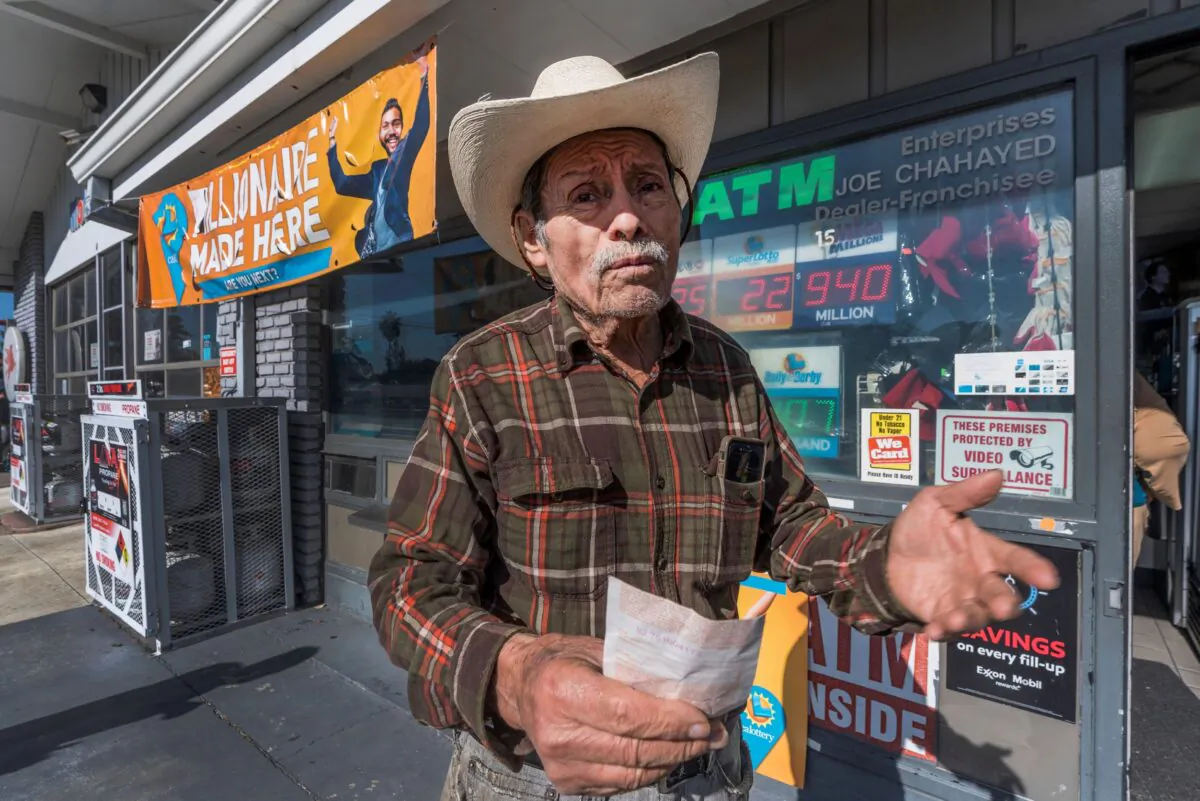 Roberto Ramirez, 77, from Guadalajara, Mexico holds a SuperLotto Plus ticket at the gas station that previously sold the $2.04 billion-winning Powerball ticket award at Joe's Service Center, a Mobil gas station at Woodbury Road and Fair Oaks Avenue in Altadena, Calif., on Jan. 6, 2023. (Damian Dovarganes/AP Photo)