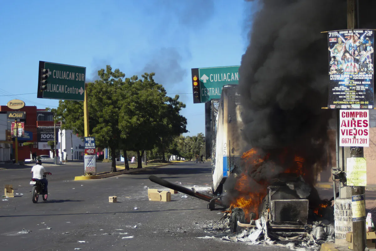 A truck burns after being set on fire amid an eruption of violence following the arrest of Ovidio Guzman Lopez, an alleged high-ranking member of a Mexican drug trafficking cartel, in Culiacan, Sinaloa, Mexico, on Jan. 5, 2023. (Martin Urista/AP Photo)