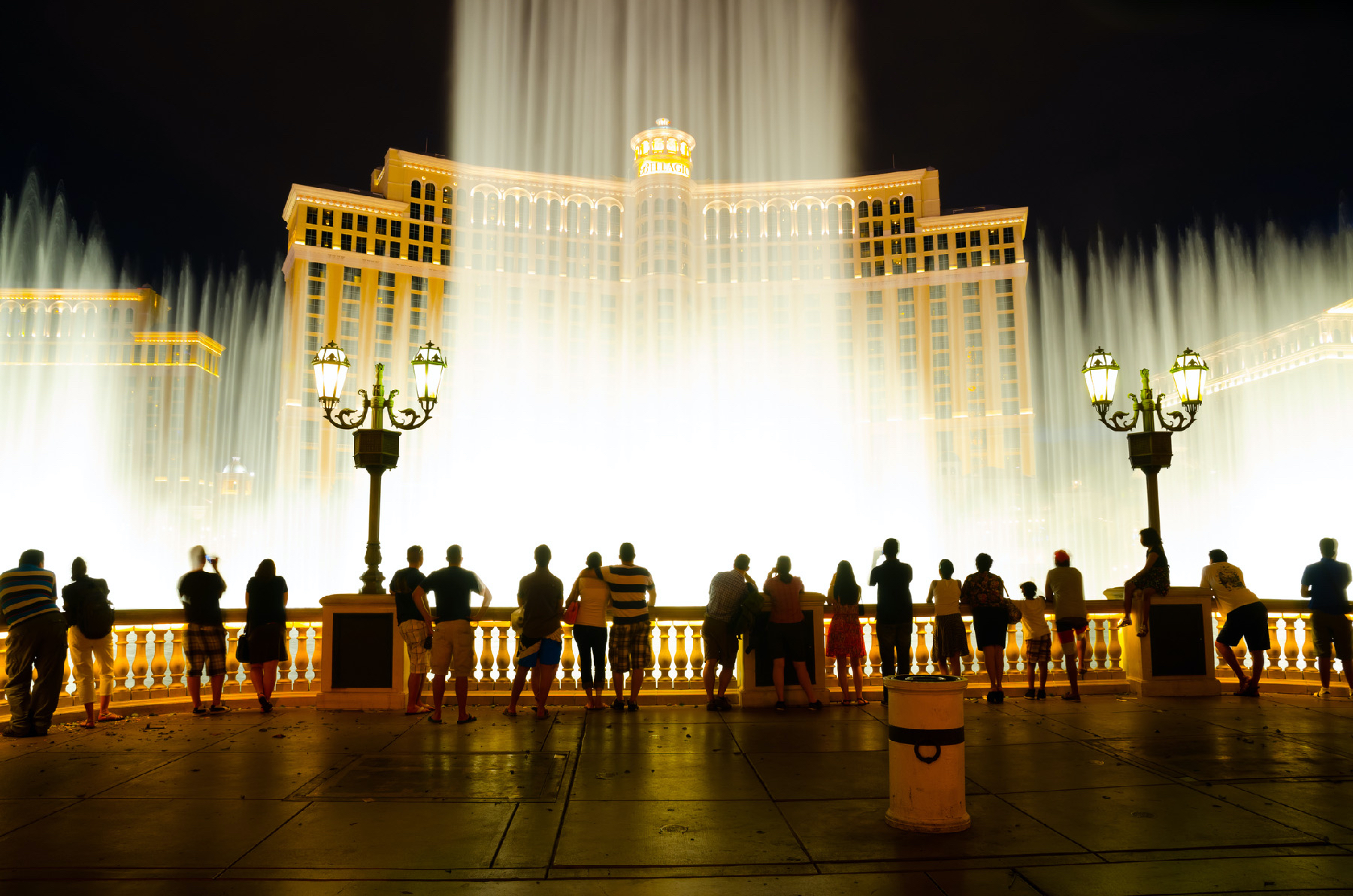 Visitors at the Bellagio Hotel in Las Vegas, Nevada, watch a performance of its iconic fountains
