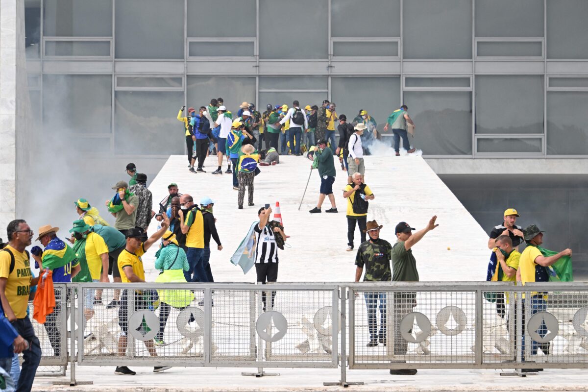 Supporters of Brazilian former President Jair Bolsonaro clash with the police during a demonstration outside Brazil's National Congress headquarters in Brasilia, Brazil, on Jan. 8, 2023. (Evaristo Sa/AFP via Getty Images)