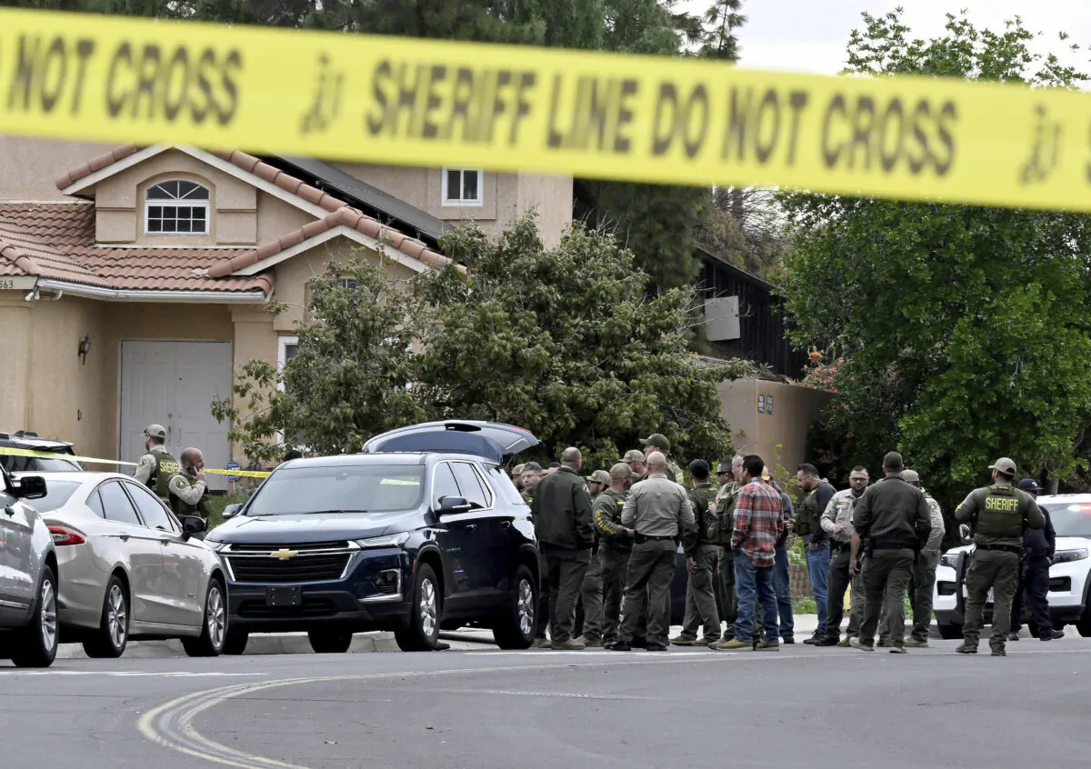 Riverside County Sheriff's stand at the corner of Golden West Ave and Condor Drive in Jurupa Valley, Calif., on Dec. 29, 2022. (Will Lester/The Orange County Register via AP)
