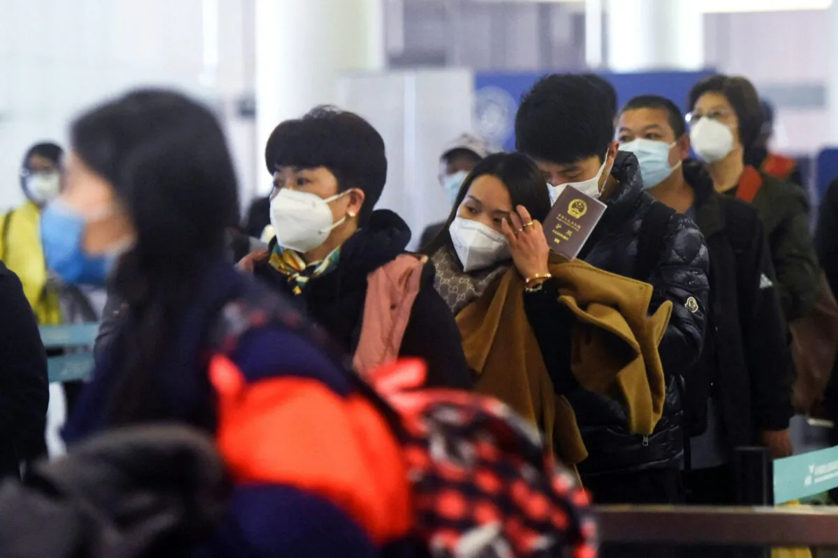 Passengers queue to pass through customs after arriving at Hangzhou Xiaoshan International Airport in China's eastern Zhejiang province on January 8, 2023. (STR/AFP via Getty Images)