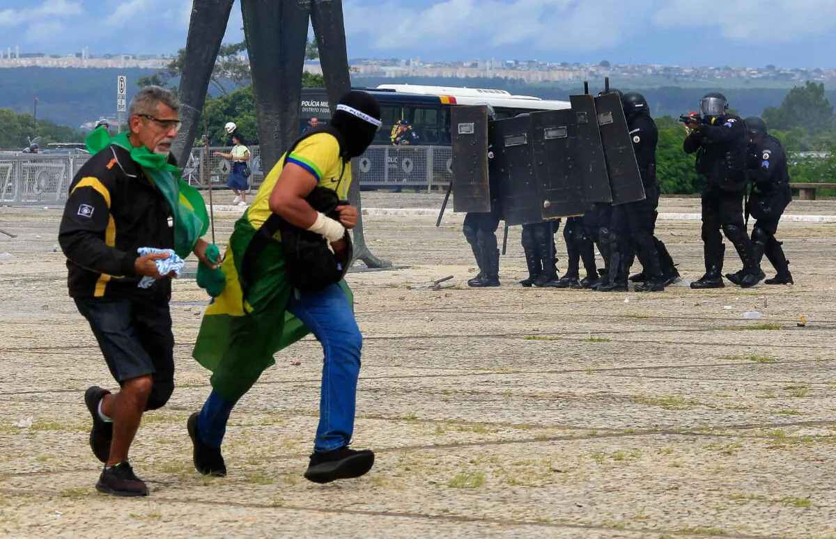 Security forces confront supporters of Brazilian former President Jair Bolsonaro as they breach the Planalto Presidential Palace in Brasilia on Jan. 8, 2023.(Sergio Lima/AFP via Getty Images)