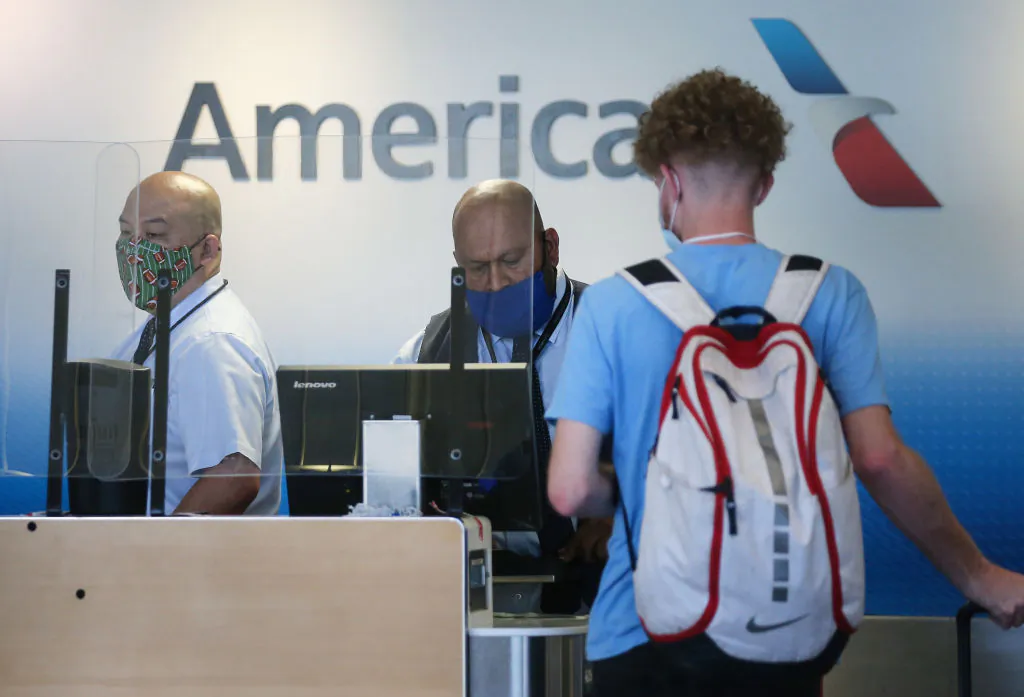 American Airlines employees work in a check-in area at Los Angeles International Airport (LAX) Los Angeles, on Oct. 1, 2020. (Mario Tama/Getty Images)