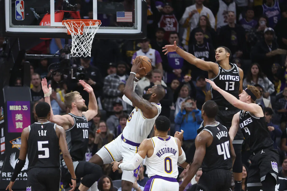 LeBron James (6) of the Los Angeles Lakers is fouled by Domantas Sabonis (10) of the Sacramento Kings on the way to the basket in the fourth quarter at Golden 1 Center in Sacramento, Calif., on Jan. 7, 2023. (Lachlan Cunningham/Getty Images)