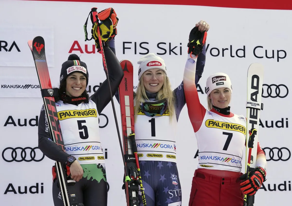 United States' Mikaela Shiffrin (C), winner of an alpine ski, women's World Cup giant slalom race, celebrates on podium with second-placed Italy's Federica Brignone (L) and third-placed Switzerland's Lara Gut Behrami, in Kranjska Gora, Slovenia, on Jan. 8, 2023. (Giovanni Auletta/AP Photo)