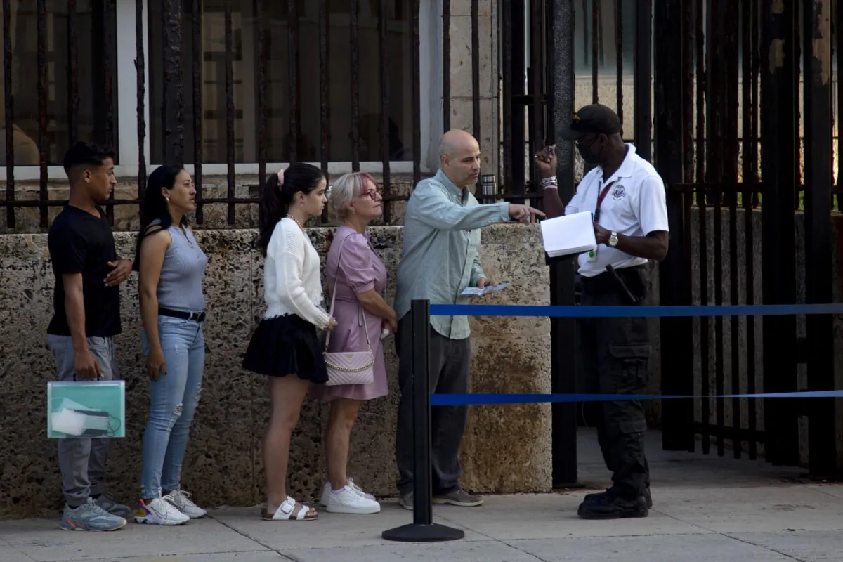 People stand in line outside the U.S. embassy on the day of its reopening for visa and consular services in Havana, Cuba, on Jan. 4, 2023. (Ismael Francisco/AP Photo)