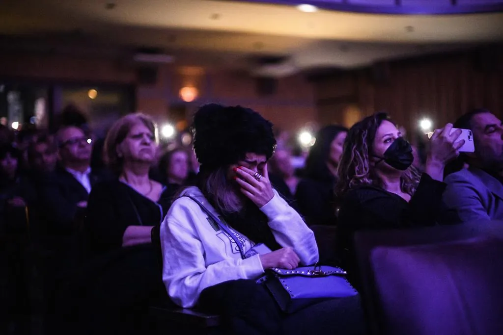 People grieve during a ceremony marking the three-year anniversary of the downing of flight PS752, in Toronto on Jan. 8, 2023. (The Canadian Press/Christopher Katsarov)