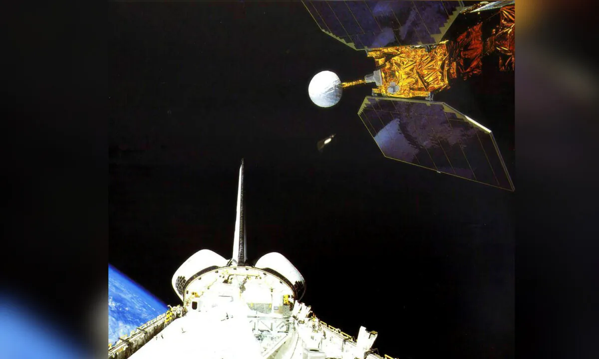 The space shuttle Challenger launches the Earth Radiation Budget Satellite in 1984. (NASA via AP)