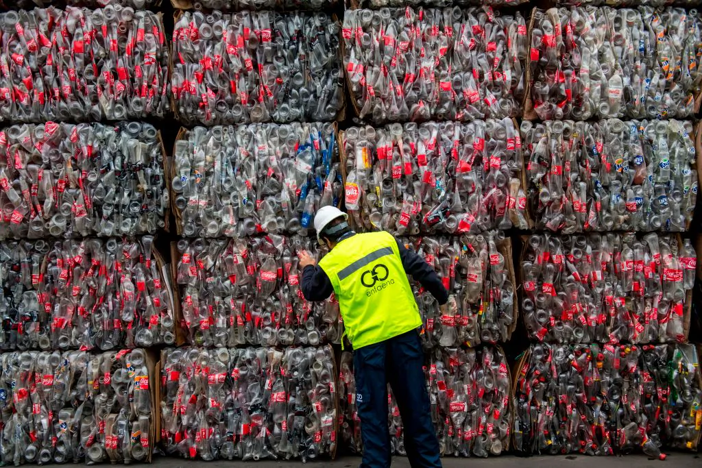 A recycling technician checks pressed plastic bottles at a recycling plant in Santiago, on Aug. 21, 2019. (Martin Bernetti/AFP via Getty Images)