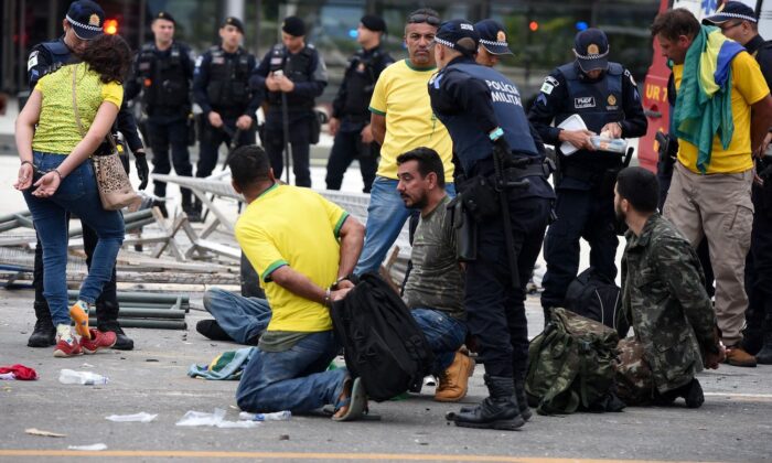 Security forces arrest rioters after retaking control of Planalto Presidential Palace in Brasilia on Jan. 8, 2023. (Ton Molina/AFP via Getty Images)