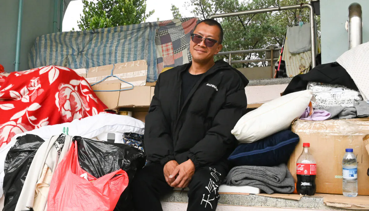 Cheung is sitting in a playground stand in Cheung Sha Wan, Hong Kong, on Jan. 3, 2023. (Zhu Li/The Epoch Times)