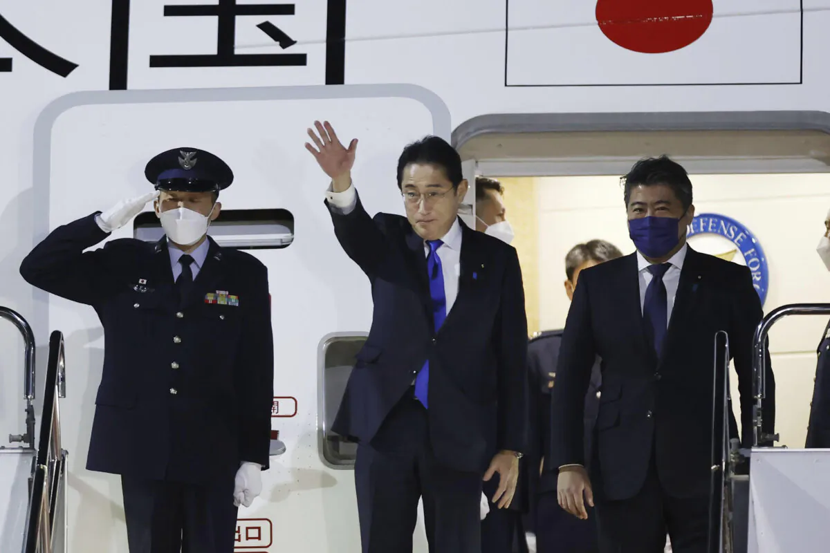 Japanese Prime Minister Fumio Kishida (C) prepares to leave Haneda airport in Tokyo on Jan. 8, 2023. (Kota Endo/Kyodo News via AP)