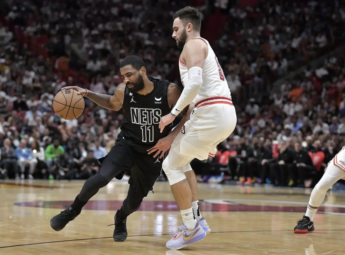 Brooklyn Nets guard Kyrie Irving (11) bumps into Miami Heat guard Max Strus (31) during the fourth quarter at FTX Arena in Miami on Jan. 8, 2023. (Michael Laughlin-USA TODAY Sports via Field Level Media)