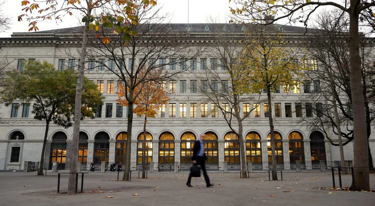 A man walks past the Swiss National Bank (SNB) building in Zurich on Oct. 31, 2013. (Arnd Wiegmann/Reuters)