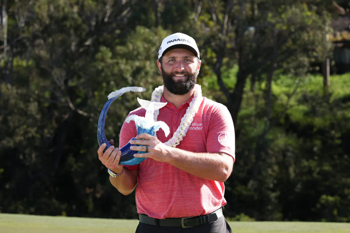Jon Rahm of Spain celebrates with the trophy after winning during the final round of the Sentry Tournament of Champions at Plantation Course at Kapalua Golf Club in Lahaina, Hawaii, on Jan. 8, 2023. (Harry How/Getty Images)