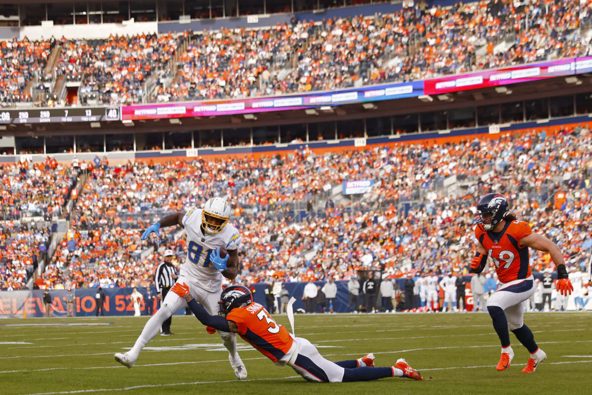 Justin Simmons (31) of the Denver Broncos tackles Mike Williams (81) of the Los Angeles Chargers while Alex Singleton (49) of the Denver Broncos pursues during the second quarter at Empower Field At Mile High in Denver on Jan. 8, 2023. (Justin Edmonds/Getty Images)
