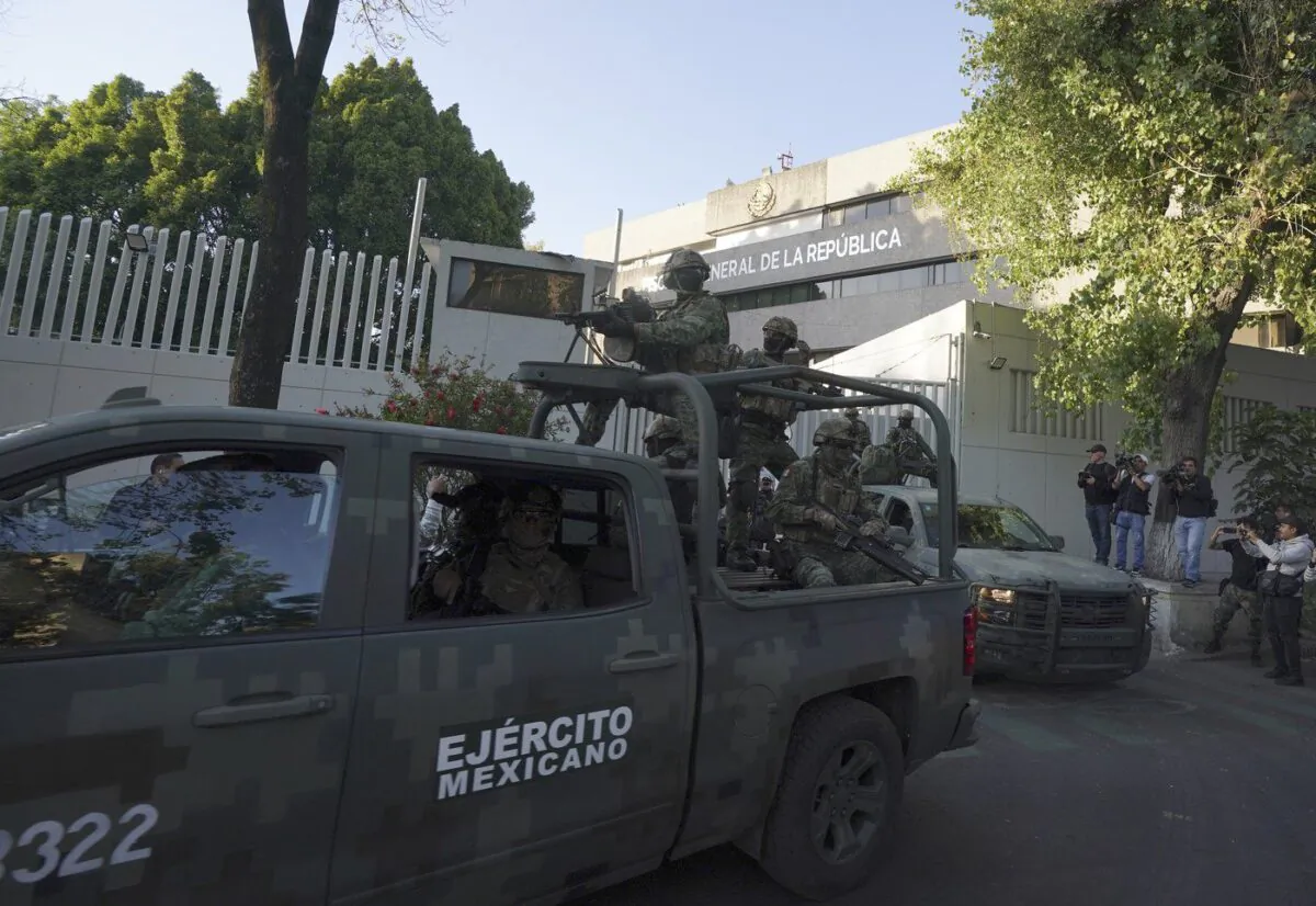 A heavily armed army convoy departs the prosecutor's building where Ovidio Guzmán, one of the sons of former Sinaloa cartel boss Joaquin "El Chapo" Guzmán, is in custody in Mexico City, on Jan. 5, 2023. (The Canadian Press/AP/Fernando Llano)