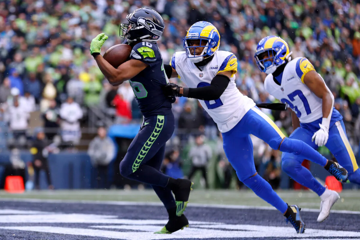 Tyler Lockett (16) of the Seattle Seahawks catches a pass over Troy Hill (2) of the Los Angeles Rams for a touchdown during the third quarter at Lumen Field in Seattle on Jan. 8, 2023. (Steph Chambers/Getty Images)