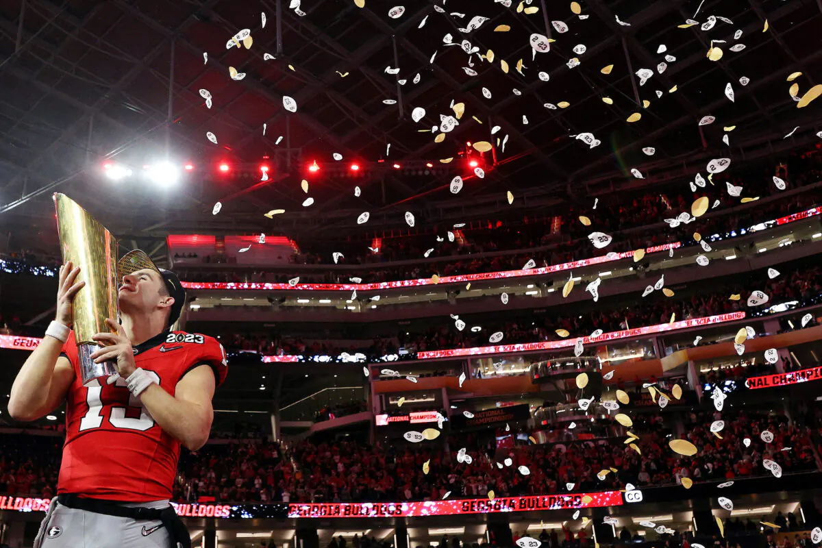 Stetson Bennett (13) of the Georgia Bulldogs celebrates with the College Football Playoff National Championship Trophy after defeating the TCU Horned Frogs in the College Football Playoff National Championship game at SoFi Stadium in Inglewood, Calif.,  on Jan. 9, 2023. (Ezra Shaw/Getty Images)