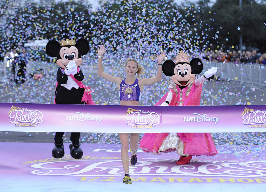 Rachel Booth, 31, of Mandeville, Louisiana, crosses the finish line to capture the 2012 Disney's Princess Half Marathon title at Walt Disney World Resort in Lake Buena Vista, Florida on Feb. 26, 2012. (Preston Mack/Disney Parks via Getty Images)