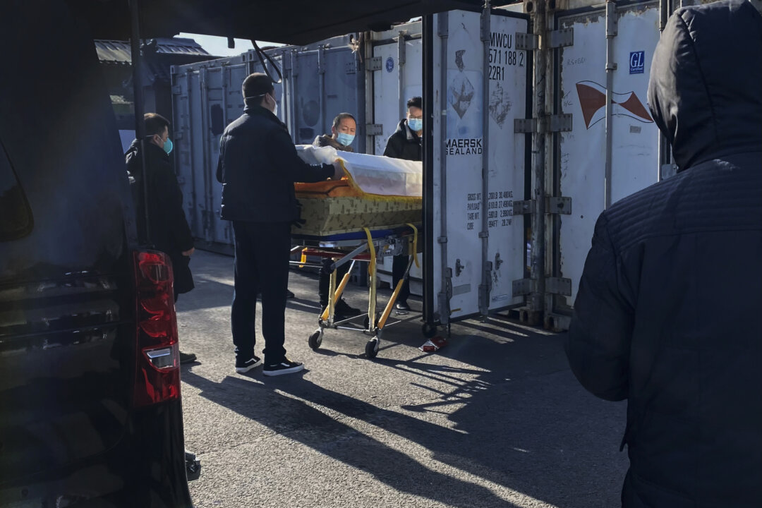 A coffin is loaded from a hearse into a storage container at the Dongjiao crematorium and funeral home, one of several in the city that handles COVID-19 cases, in Beijing, China, on Dec. 18, 2022. (Getty Images)