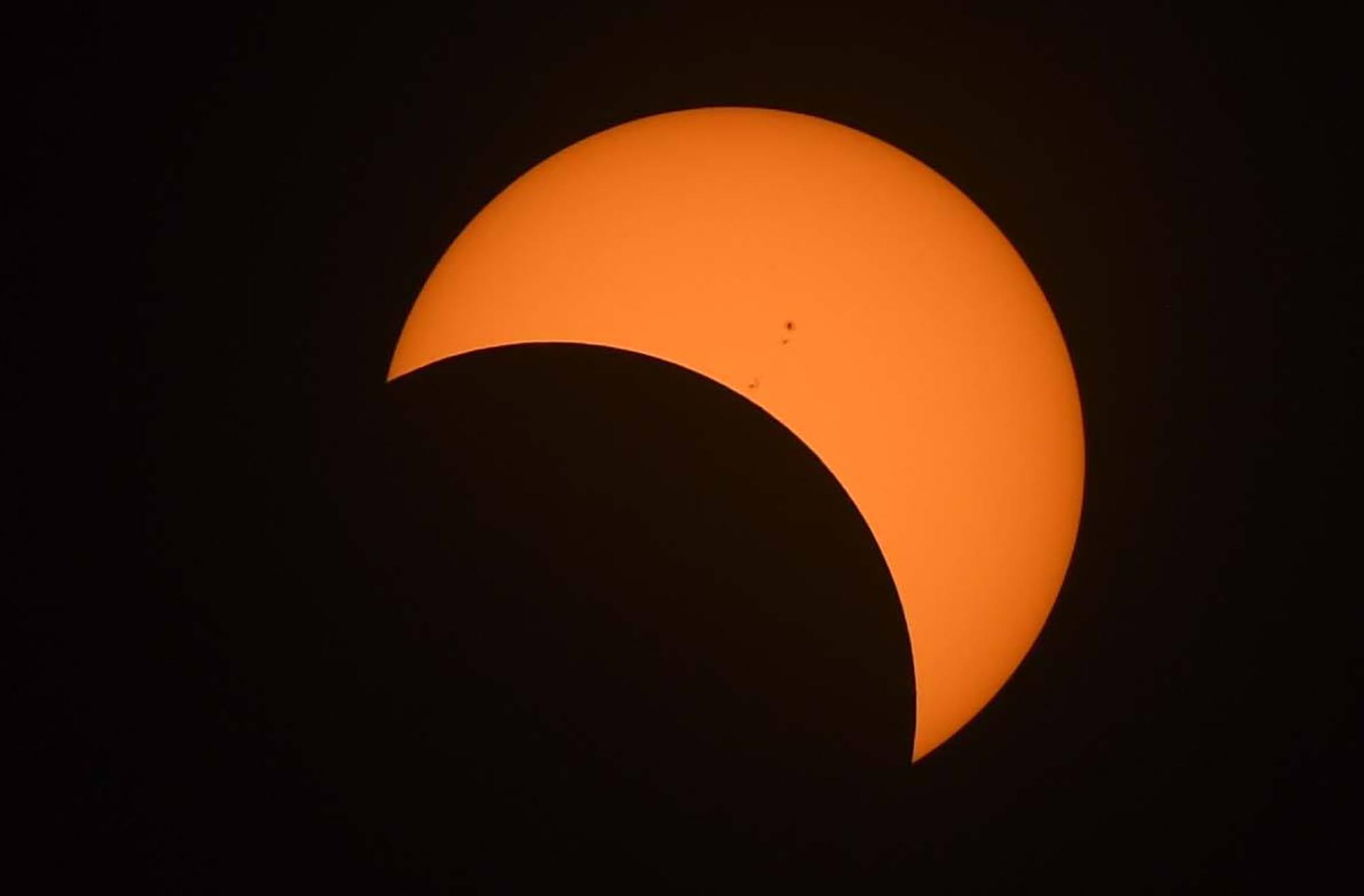 The moon moves in front of the sun during the Great American eclipse in Oregon in August 2017.