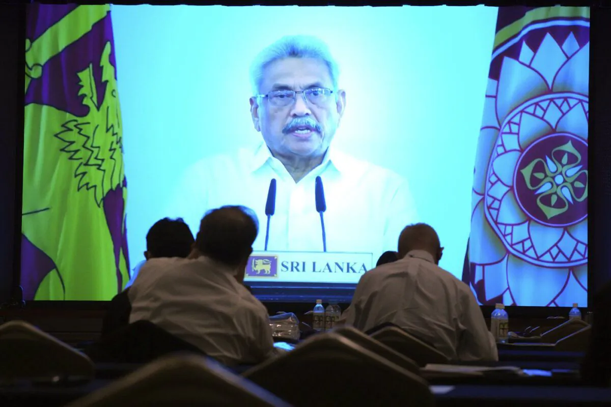 Participants look at Sri Lankan President Gotabaya Rajapaksa's pre-recorded speech shown on a screen at a session of the International Conference on "The Future of Asia", May 26, 2022 in Tokyo. (The Canadian Press/AP-Eugene Hoshiko)
