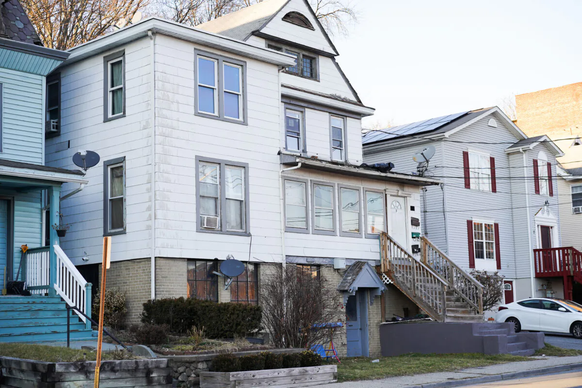 An under-mantained rental property (C) not far from downtown Middletown, N.Y., on Jan. 9, 2023. (Cara Ding/The Epoch Times)