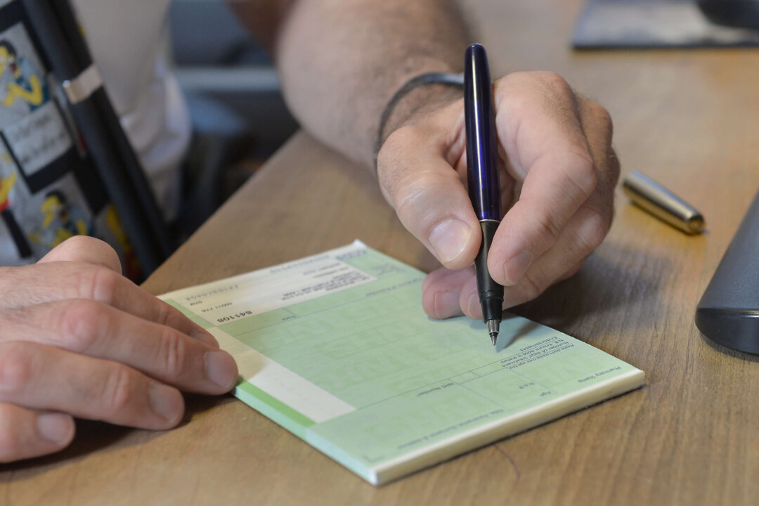 File photo of a GP writing a prescription in the United Kingdom, on Sept. 10, 2014. (PA Media) 