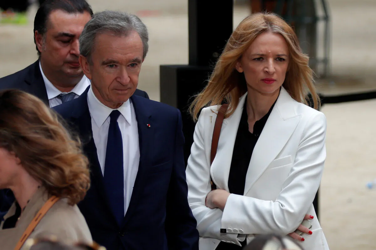 Bernard Arnault, CEO of LVMH Moet Hennessy Louis Vuitton SE, and Delphine Arnault, Executive Vice President of Louis Vuitton, leave after the Spring/Summer 2020 collection show for fashion house Louis Vuitton during Men's Fashion Week in Paris on June 20, 2019. (Charles Platiau/Reuters)
