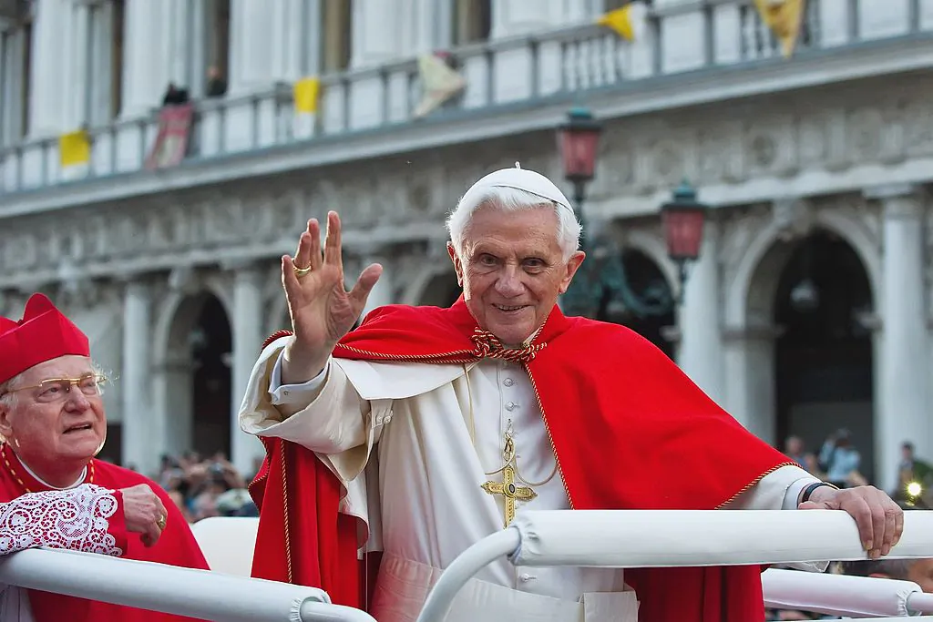 Pope Benedict XVI (R) greets the crowd gathered in St Mark's Square while crossing the square on an electric vehicle in Venice, Italy, on May 7, 2011. (Marco Secchi/Getty Images)
