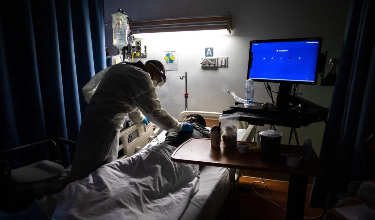 A doctor checks on a 34-year-old COVID-19 patient at a medical center in Tarzana, Calif., on Sept. 2, 2021. (Apu Gomes/AFP via Getty Images)