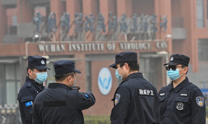 Security personnel stand guard outside the Wuhan Institute of Virology in Wuhan as members of the World Health Organization (WHO) team investigating the origins of the COVID-19 coronavirus make a visit to the institute in Wuhan in China's central Hubei province on Feb. 3, 2021. (Hector Retamal/AFP via Getty Images)
