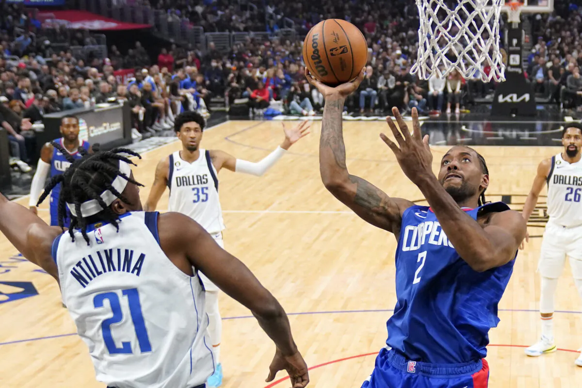 Los Angeles Clippers forward Kawhi Leonard, right, shoots as Dallas Mavericks guard Frank Ntilikina during the first half of an NBA basketball game in Los Angeles on Jan. 10, 2023. (Mark J. Terrill/AP Photo)