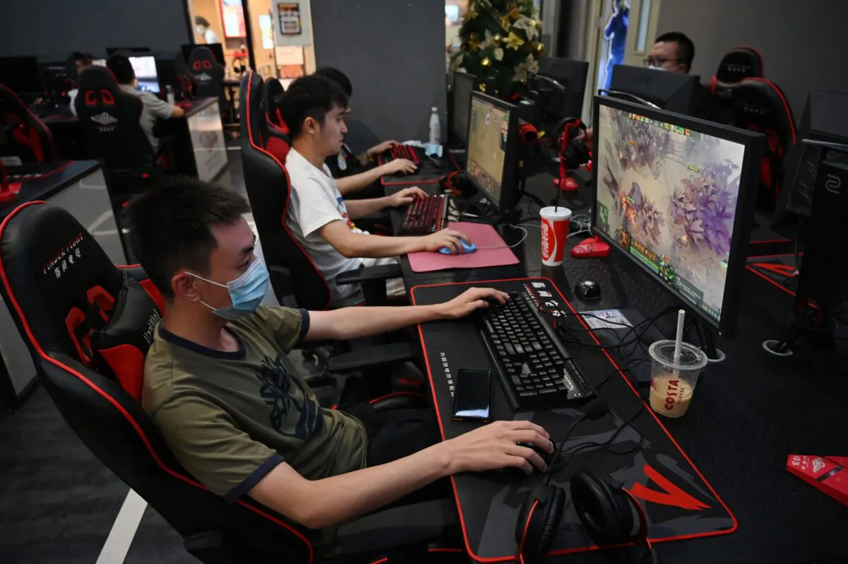 People play computer games at an internet cafe in Beijing on Sept. 10, 2021. (Greg Baker/AFP via Getty Images)