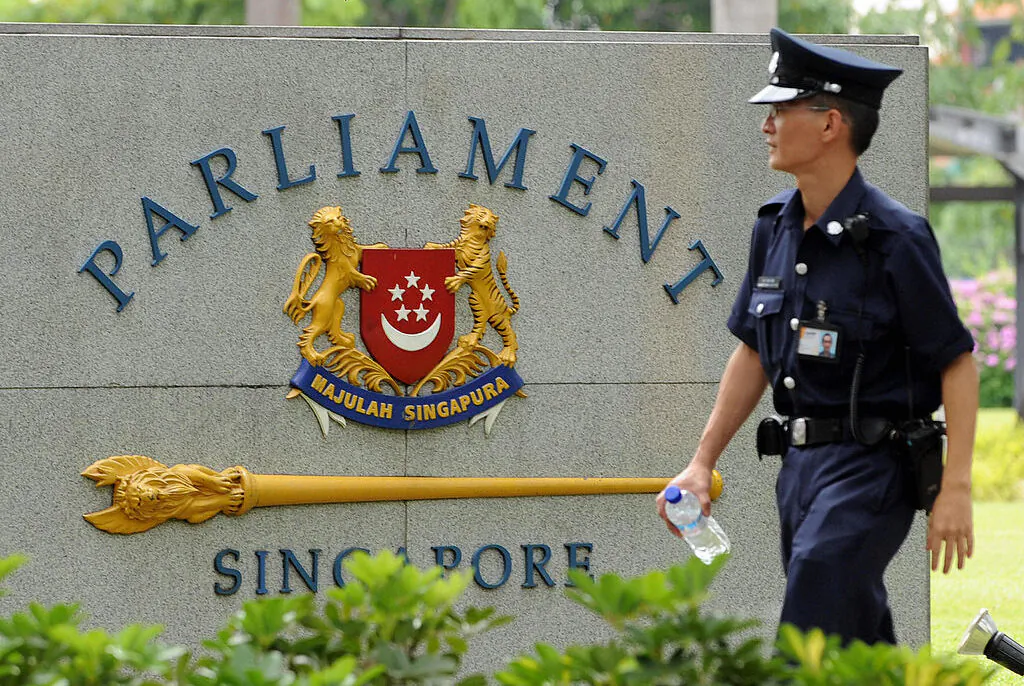 A security policeman patrols Singapore's Parliament House on Feb. 15, 2008. (Roslan Rahman/AFP via Getty Images)