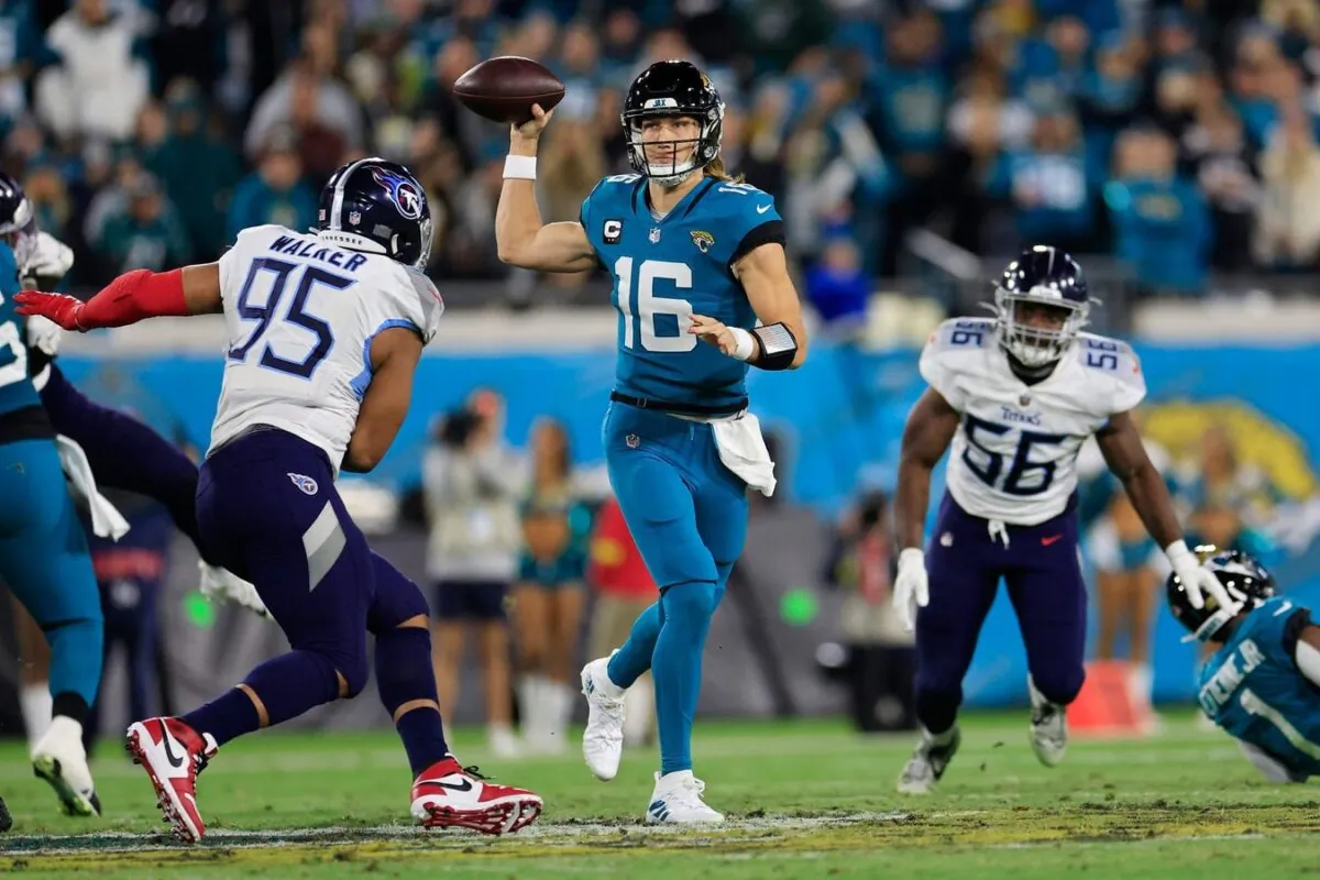 Jacksonville Jaguars quarterback Trevor Lawrence (16) looks to pass against Tennessee Titans defensive end DeMarcus Walker (95) during the second quarter of an NFL football regular season matchup, the Jaguars held off the Titans 20–16, AFC South division title game at TIAA Bank Field in Jacksonville, Fla., on Jan. 7, 2023. (Corey Perrine/Florida Times-Union via Field Level Media)