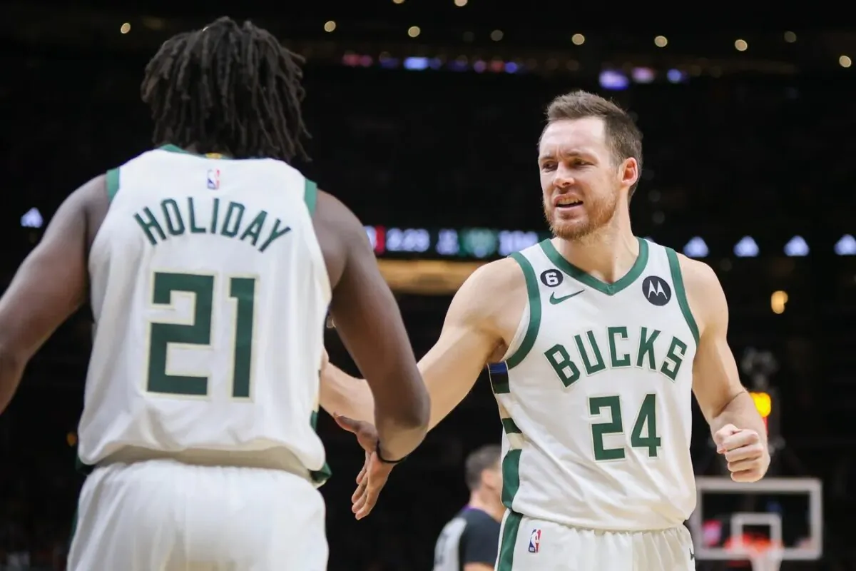Milwaukee Bucks guard Pat Connaughton (24) reacts with guard Jrue Holiday (21) against the Atlanta Hawks in the second half at State Farm Arena in Atlanta on Jan. 11, 2023. (Brett Davis-USA TODAY Sports via Field Level Media)