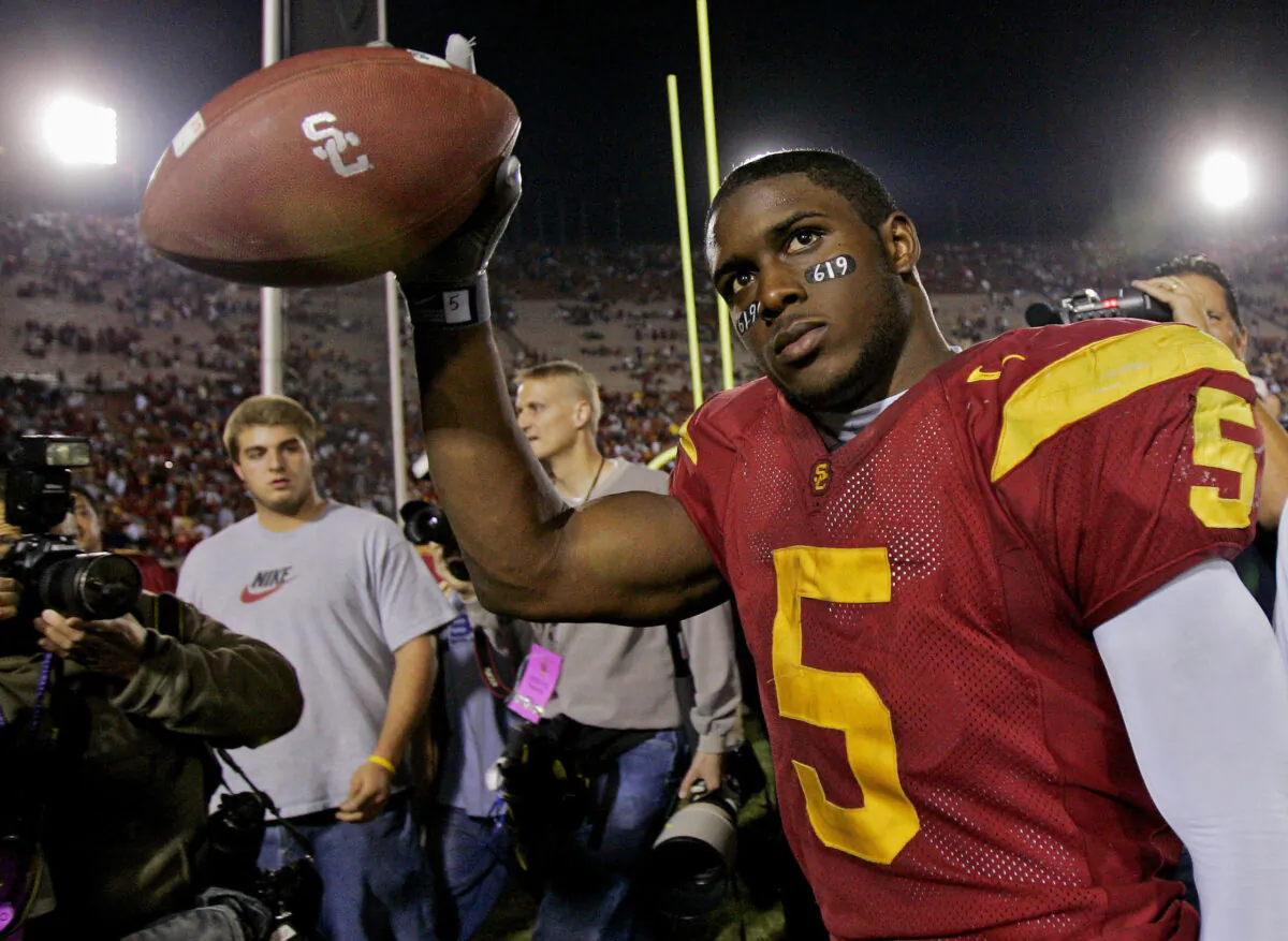 Southern California tailback Reggie Bush walks off the field holding the game ball after the Trojans defeated Fresno State, 50-42, at the Los Angeles Coliseum in Los Angeles on Nov. 19, 2005. (Kevork Djansezian/AP Photo)