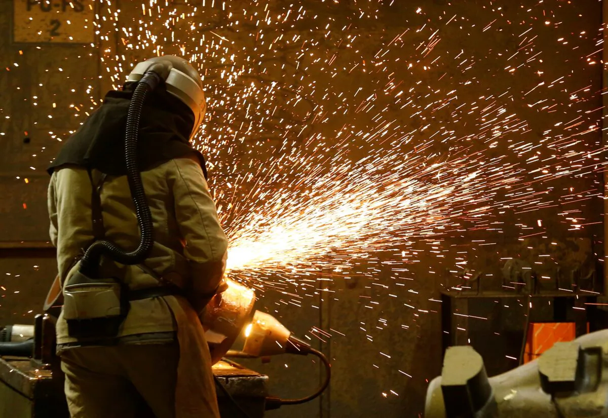 A steel worker grinds a steel cast at ‘Friedrich Wilhelms-Huette (FWH) Stahlguss' steel casting firm in Muelheim an der Ruhr, Germany, on April 2, 2022. (Thilo Schmuelgen/Reuters)