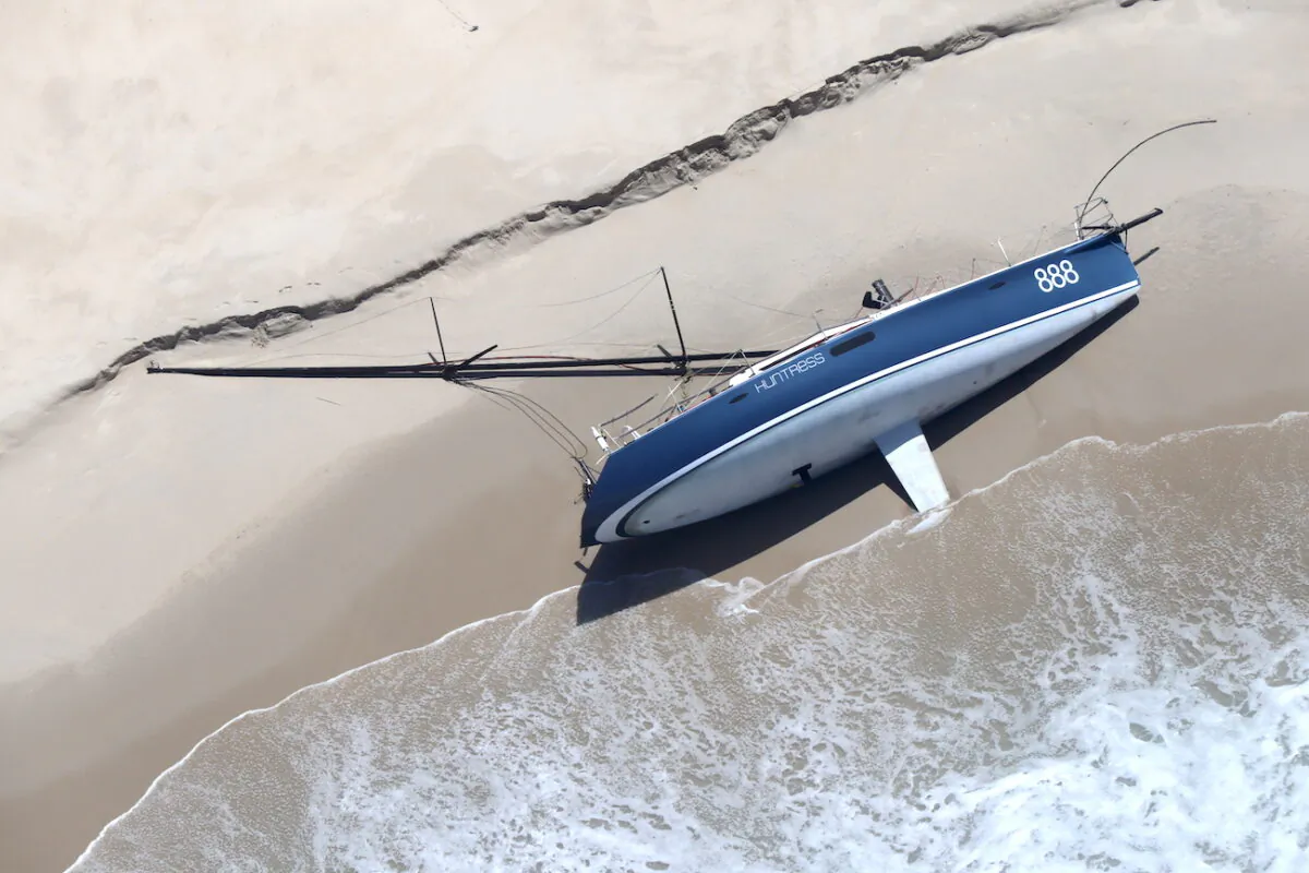 A supplied image shows a yacht, abandoned during the Sydney to Hobart Yacht Race, washed up at Christmas Beach on truwana/Cape Barren Island, Tasmania, on Jan. 5, 2023. (AAP Image/Supplied by Vica Bayley, Aboriginal Land Council of Tasmania)